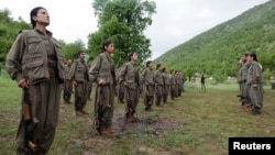 FILE - Kurdistan Workers Party (PKK) fighters stand at formation in northern Iraq, May 14, 2013. 