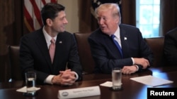 U.S. President Donald Trump talks with House Speaker Paul Ryan (R-WI) as he promotes a newly unveiled Republican tax plan with House Republican leaders in the Cabinet Room of the White House in Washington, Nov. 2, 2017. 