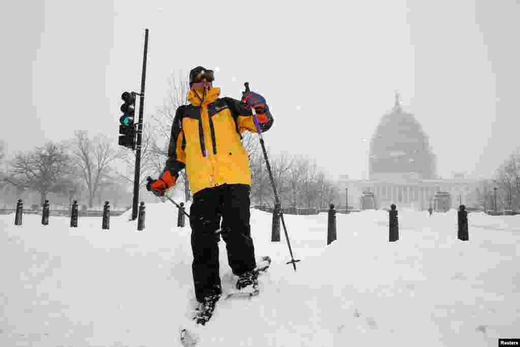 A person skis on the grounds of the U.S. Capitol as snow continues to fall in Washington January 23, 2016. Heavy snow covered the eastern U.S. from North Carolina to New York. REUTERS/Jonathan Ernst