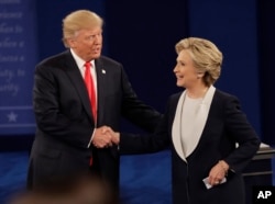 Republican presidential nominee Donald Trump shakes hands with Democratic presidential nominee Hillary Clinton following the second presidential debate at Washington University in St. Louis, Oct. 9, 2016.