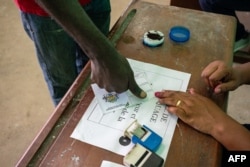 A elector  registers to ballot  astatine  a polling presumption    during Gabon's referendum successful  Libreville, Nov. 16, 2024.