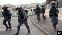 Israeli riot police officers operate in the Arab neighborhood of Issawiyeh in Jerusalem, Oct. 20, 2015.