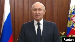 Russian President Vladimir Putin gives a televised address in Moscow