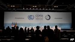 COP25 party members talk ahead of the closing plenary in Madrid, Spain, Dec. 15, 2019. 