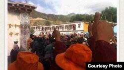 FILE - Tibetan protesters in Denma give the thumbs up sign during a protest in August.