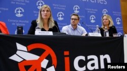 FILE - Beatrice Fihn, executive director of the International Campaign to Abolish Nuclear Weapons (ICAN), and other members of the organization attend a news conference after ICAN won the Nobel Peace Prize 2017, in Geneva, Switzerland, Oct. 6, 2017.