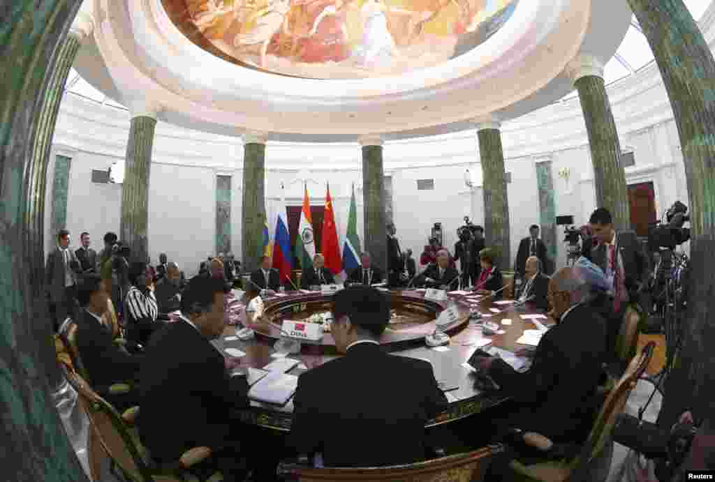 Participants sit at a table during a BRICS leaders' meeting at the G20 Summit in Strelna near St. Petersburg, Sept. 5, 2013. 