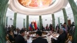 Participants sit at a table during a BRICS leaders' meeting at the G20 Summit in Strelna near St. Petersburg, Sept. 5, 2013. 