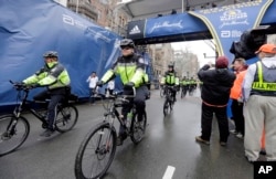 FILE - Police officers patrol near the finish line of the Boston Marathon in Boston, April 20, 2015.