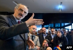 Syrian ambassador to the UN and head of the government delegation Bashar al-Jaafari gestures as he holds a press conference during the Syria peace talks in Geneva, Jan. 31, 2016.