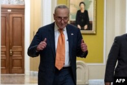 FILE - US Senate Majority Leader Chuck Schumer (D-NY) gives a thumbs up after voting on the continuing resolution passed by the House earlier in the day on Capitol Hill in Washington, DC on September 30, 2023.