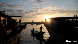 The sun rises as fishermen are seen at the seaport of Gaza City, after Israel expanded fishing zone for Palestinians, April 2, 2019.
