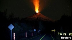 Smoke and lava spew from the Villarrica volcano, as seen from Pucon town, in the south of Santiago, Chile, April 22, 2015. 