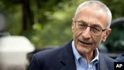 Hillary Clinton campaign chairman John Podesta speaks to members of the media outside Clinton's home in Washington, Oct. 5, 2016.