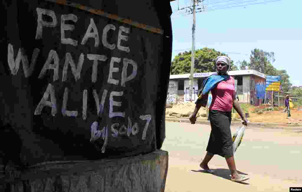 I want to remind Kenyans to vote peacefully in the elections. And to the survivors of the 2007/2008 post election violence, especially those in the Rift Valley region, I say you need to remain positive and hopeful... - James Ruei Majok in Bentiu, Unity state. A woman walks past a message of peace in Kibera slum in the capital Nairobi, February 28, 2013.