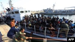 Migrants of different African nationalities arrive at a naval base in the Libyan capital Tripoli, April 22, 2018, after being rescued off the coast of Zliten from two inflatable boats.