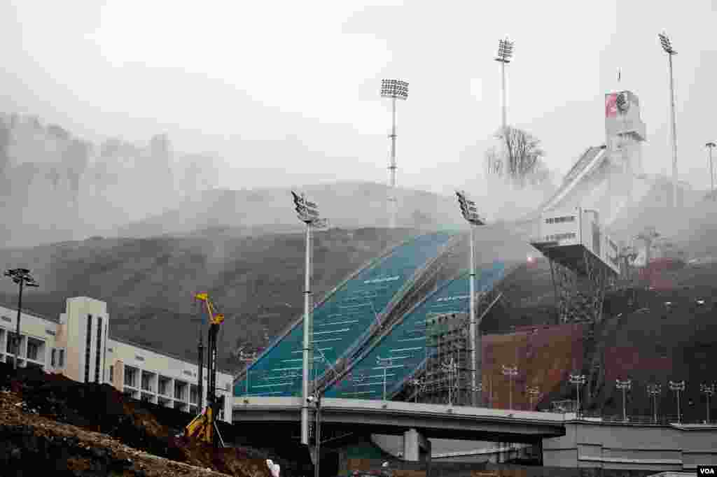 The Olympic ski jump rises from the mountain mists above Sochi. The jump’s price tag: $265 million. (V. Undritz for VOA)