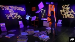 A pizza box playroom created with neon lights and colorful fluorescent tape called "Gazoo," is part of a group art exhibition celebrating pizza at The Museum of Pizza in New York, Nov. 2, 2018. 