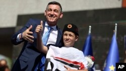 Kadri Veseli, leader of the ruling Democratic Party of Kosovo (PDK), is greeted by a supporter during the opening electoral rally in Kosovo's capital, Pristina, May 31, 2017.