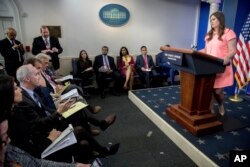 FILE - Associated Press White House Reporter Ken Thomas, second from left, asks a question to White House deputy press secretary Sarah Huckabee Sanders during the daily press briefing at the White House in Washington, May 5, 2017.