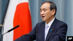 FILE PHOTO - Japan's Chief Cabinet Secretary Yoshihide Suga speaks during a press conference to announce the new line up of Cabinet at the prime minister's official residence in Tokyo, Thursday, Aug. 3, 2017. 