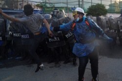 Demonstrators clash with riot police officers during an anti-government protest in Bangkok, Nov. 17, 2020.