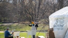 Volunteers assemble sinks at the Samaritan's Purse field hospital in New York's Central Park, Wednesday, April 1, 2020.