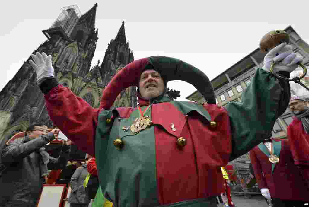A reveler celebrates in front of the cathedral during the start of the Women&#39;s Street Carnival in Cologne, Germany.
