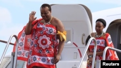 FILE - King of Swaziland Mswati III and one of his 13 wives disembark from a plane after arriving at Katunayake International airport in Colombo, Sri Lanka, Aug. 13, 2012. 