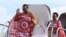 FILE - King of Swaziland Mswati III and one of his 13 wives disembark from a plane after arriving at Katunayake International airport in Colombo, Sri Lanka, August 13, 2012. 