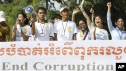 Social activists carry an anti-corruption banner during a rally in Phnom Penh, Cambodia, file photo. 