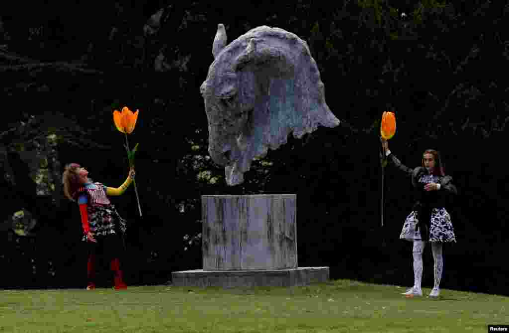 Dancers perform next to a sculpture entitled &quot;Into the Wind&quot; by Nic Fiddian-Green during the Chatsworth Outdoors exhibition at Chatsworth House near Edensor, Britain.