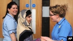 This photo made available by Queen Elizabeth Hospital shows Malala Yousafzai saying goodbye as she is discharged from the hospital to continue her rehabilitation at her family’s temporary home, Birmingham, England, Jan. 4, 2013.