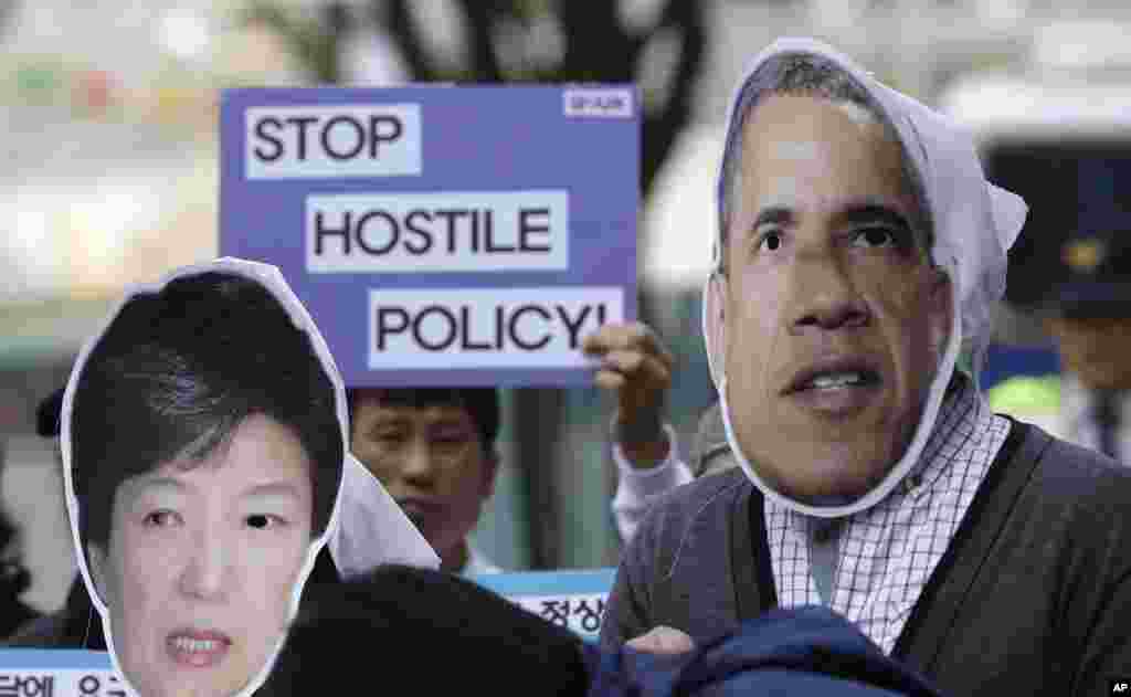 South Korean protesters wear masks of U.S. President Barack Obama and South Korean President Park Geun-hye during a rally denouncing their policy toward North Korea near the U.S. Embassy in Seoul, May 6, 2013.