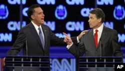 Republican presidential candidates former Massachusetts Gov. Mitt Romney, left, and Texas Gov. Rick Perry argue during a Republican presidential debate in Las Vegas, October 18, 2011.
