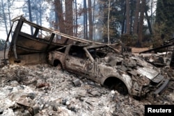 A car destroyed by the Camp Fire is seen in Paradise, California, Nov. 13, 2018.