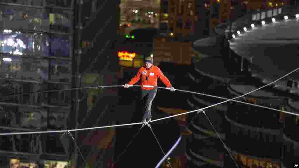 Nik Wallenda walks over the Chicago River uphill nearly eight stories for Discovery Channel's Skyscraper Live with Nik Wallenda, Nov. 2, 2014. 