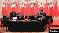 FILE - King Tupou VI of Tonga and Chinese President Xi Jinping attend a signing ceremonyat The Great Hall Of The People, in Beijing, China, March 1, 2018.