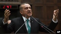 Turkey's Prime Minister Recep Tayyip Erdogan addresses his supporters at the parliament in Ankara, Jan. 14, 2014.