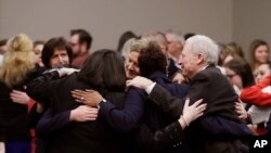 Victims and supporters react after Larry Nassar was sentenced to 40 to 175 years in prison, during a sentencing hearing, Jan. 24, 2018, in Lansing, Michigan. Nassar has admitted sexually assaulting athletes when he was employed by Michigan State University and USA Gymnastics.