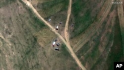 This satellite image provided by Maxar Technologies claims to show M-46 towed field guns and military vehicles positioned in the village of Serha in Eritrea, across the border from the town of Zalambessa in the Tigray region of northern Ethiopia on Monday, Sept. 19, 2022.