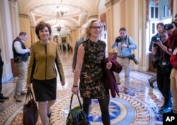 Newly-elected Democratic Senators Jacky Rosen of Nevada, left, and Kyrsten Sinema of Arizona arrive at the Capitol in Washington for a meeting with Senate Minority Leader Chuck Schumer, D-N.Y., Nov. 13, 2018.