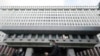 FILE - People walk in front of the Formosa Plastics Group headquarters in Taipei, Taiwan, Nov. 29, 2021. A senior executive from the company has been banned from leaving China.