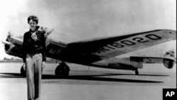 Amelia Earhart, 39, stands next to a Lockheed Electra 10E, before her last flight in 1937 from Oakland, Calif., bound for Honolulu on the first leg of her record-setting attempt to circumnavigate the world westward along the equator.