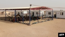 Jordan -- Syrian refugees sit at the al-Roqban makeshift camp, on the border with Syria, before being transported to the eastern town of Ruwaished, September 10, 2015