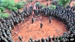 FILE - African Union Mission in Somalia (AMISOM) troops gather for a briefing before embarking on an operation. 