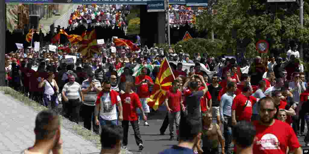People carrying banners, national flags and flags of the ethnic communities arrive in front of the Government building in Skopje, May 17, 2015.