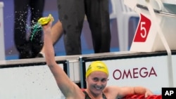Ariarne Titmus, of Australia celebrates after winning the final of the women's 400-meters freestyle at the 2020 Summer Olympics, July 26, 2021, in Tokyo, Japan.