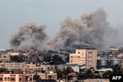 FILE - A picture taken from Rafah in the southern Gaza Strip shows smoke rising over buildings in Khan Younis in the distance, following Israeli bombardment on February 5, 2024 as fighting continues between Israel and the Palestinian Hamas group.