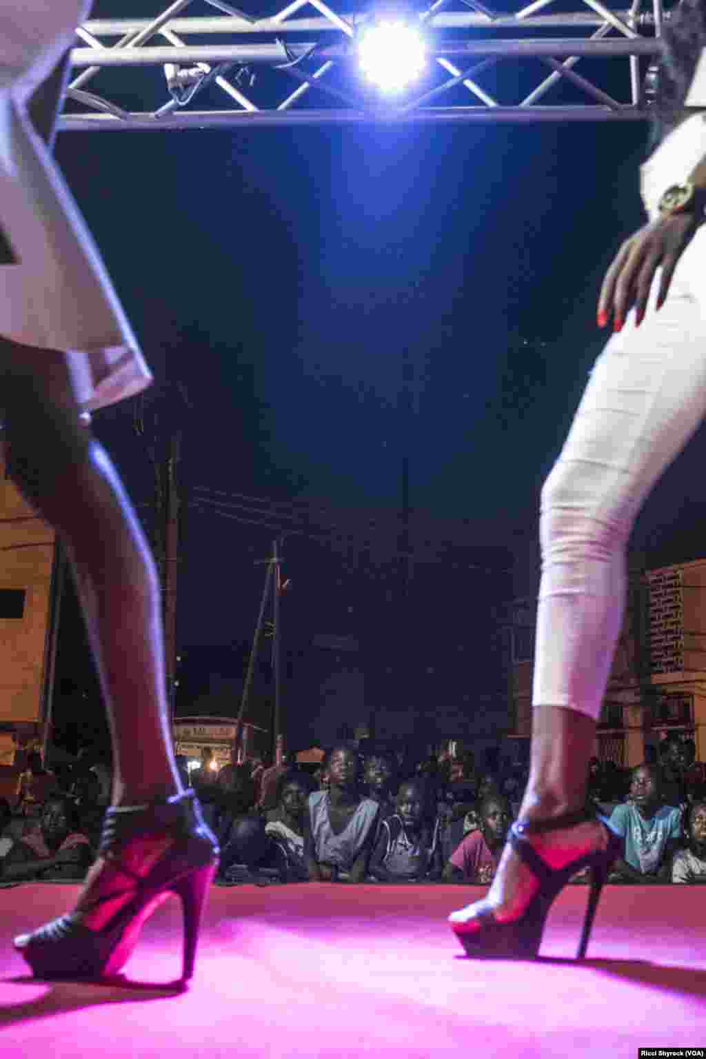 Local youth watch models on the catwalk at Dakar Fashion Week's "Street Show," which is open to the public, in the Niary Tally neighborhood. "Fashion is from the streets, so basically what we’re doing is taking back fashion where it belongs," says Dakar Fashion Week founder Adama Paris.